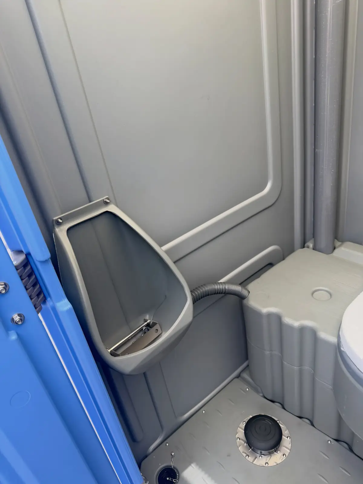 Close view of the urinal inside a standard unit