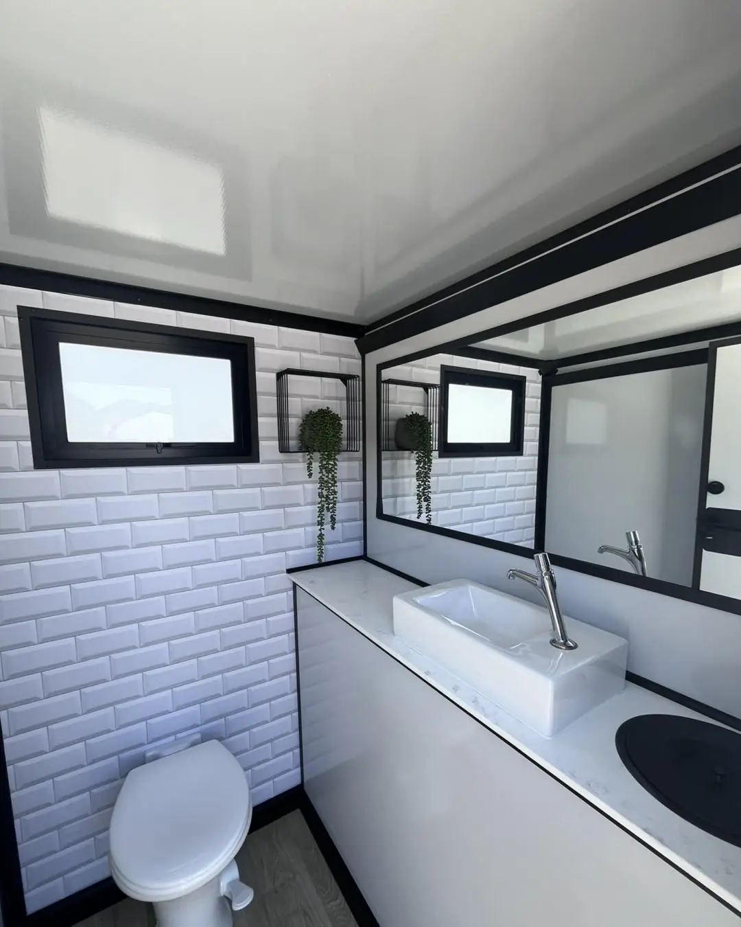 Tiled wall, window and sink inside a trailer room